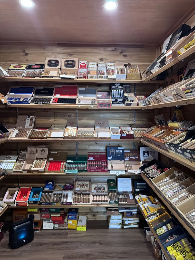 GS Vape Madison's walk-in cigar humidor room is fully stocked from floor to ceiling with premium hand-rolled cigars. Climate-controlled conditions keep every box in optimal smoking condition. Wide view of the walk-in cigar humidor room at GS Vape in Madison, Ohio