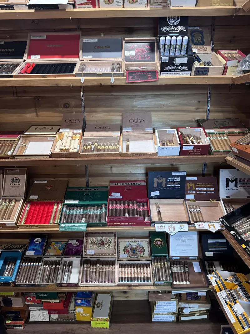 Premium cigar brands including Cohiba, Oliva, and Macanudo line the shelves of GS Vape Madison's humidor room. These top-tier boxes cater to experienced cigar enthusiasts seeking recognized names. Cohiba, Oliva, and Macanudo premium cigar boxes displayed at GS Vape in Madison, Ohio